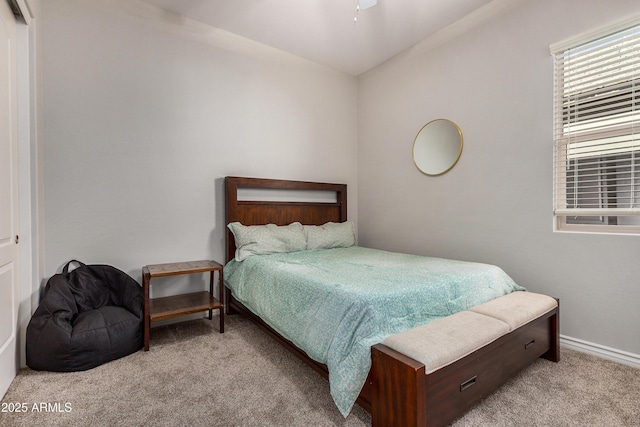 bedroom with baseboards and carpet