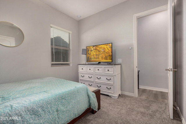 bedroom featuring baseboards and light carpet