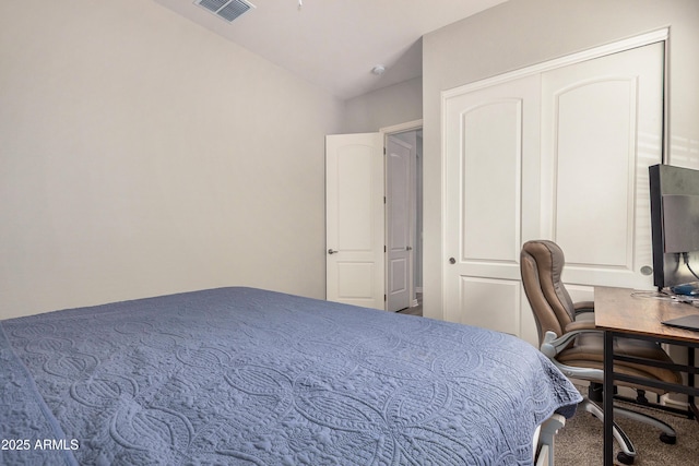 bedroom with visible vents, carpet flooring, and vaulted ceiling