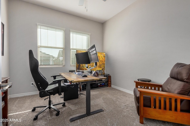 office space featuring carpet flooring, a ceiling fan, and baseboards