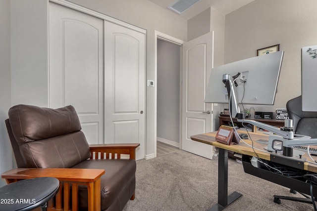 carpeted office featuring visible vents and baseboards