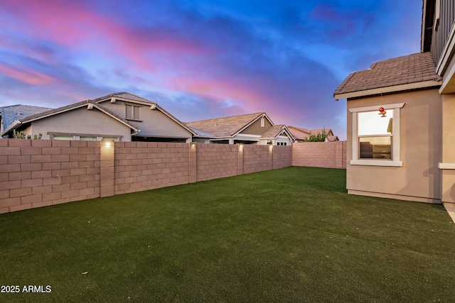 view of yard at dusk