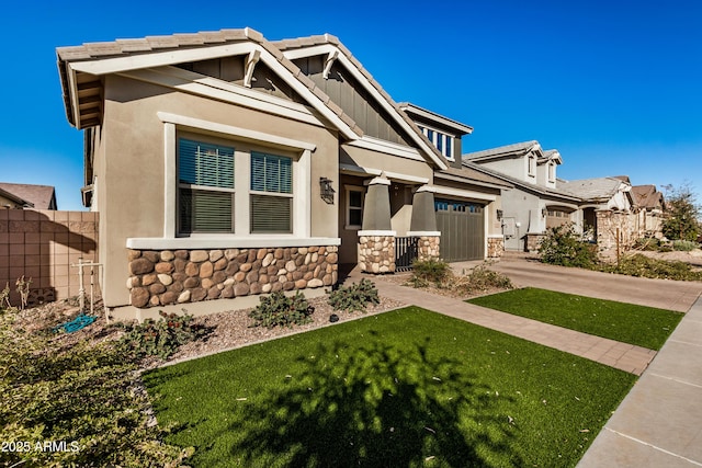 craftsman inspired home featuring a garage and a front yard