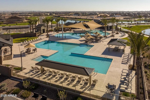 view of swimming pool with a gazebo, a patio, and a water view