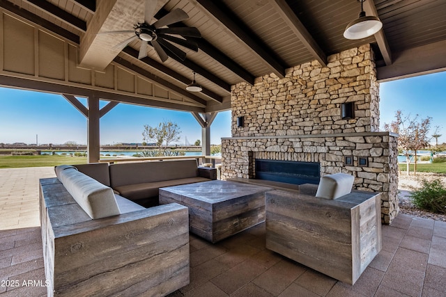 view of patio / terrace featuring an outdoor living space with a fireplace and ceiling fan