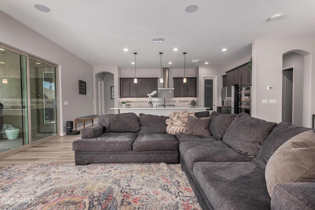 living room with sink and light hardwood / wood-style flooring