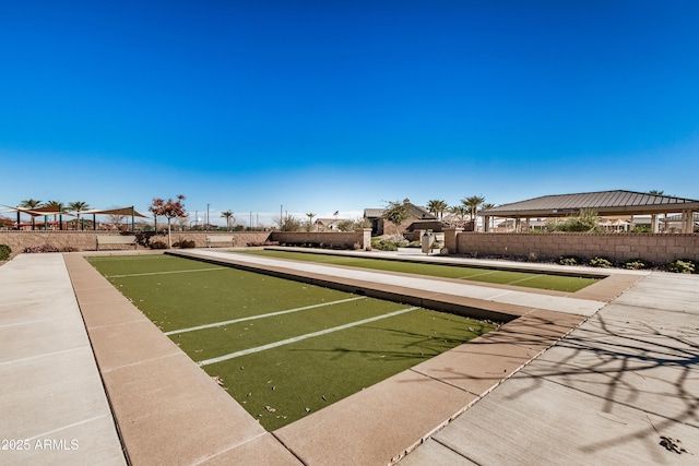 view of home's community featuring fence