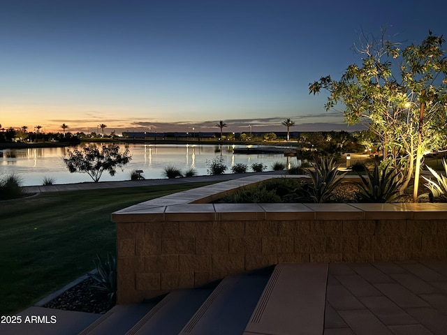 patio terrace at dusk with a water view