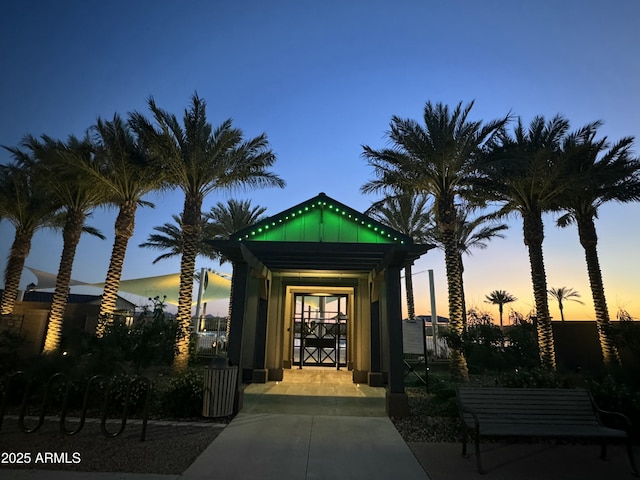 view of exterior entry at dusk