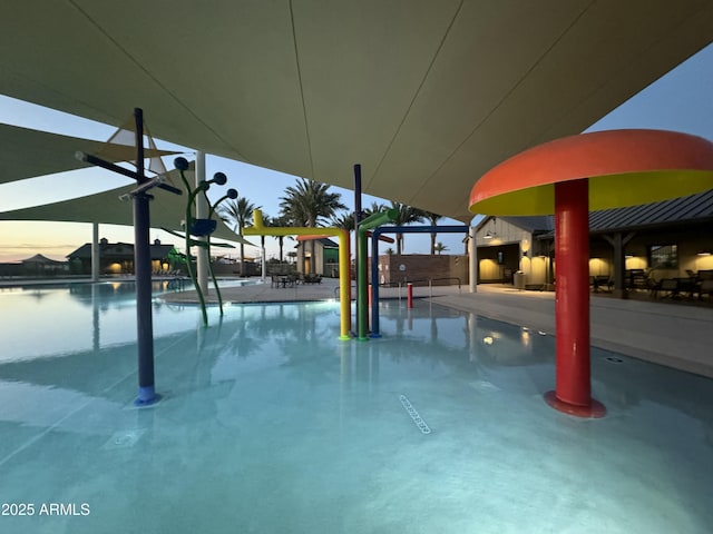 pool at dusk with a water view