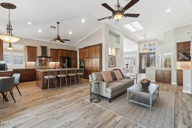 living room featuring crown molding, high vaulted ceiling, ceiling fan, and light wood-type flooring