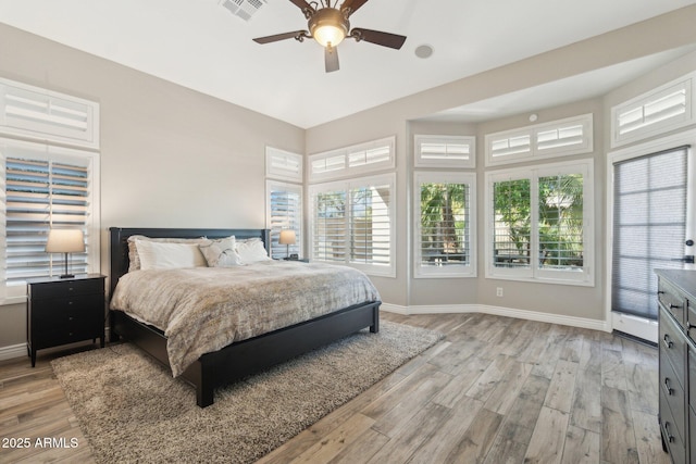 bedroom with light hardwood / wood-style flooring and ceiling fan