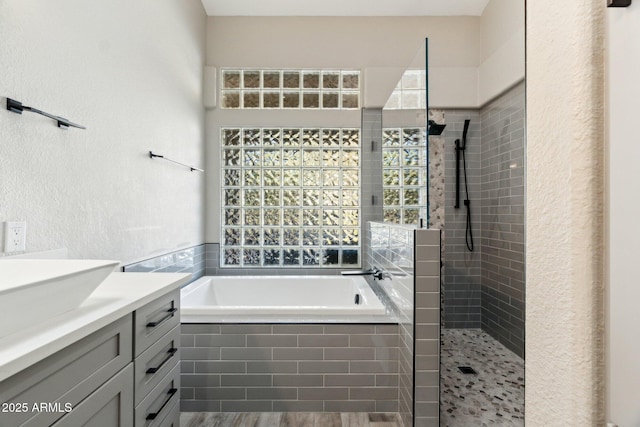 bathroom with vanity, hardwood / wood-style floors, and separate shower and tub