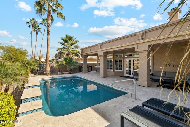 view of swimming pool with an outdoor living space and a patio area