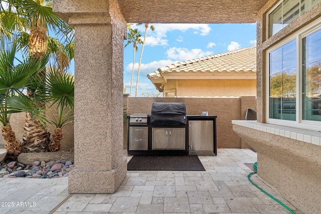 view of patio with exterior kitchen and area for grilling