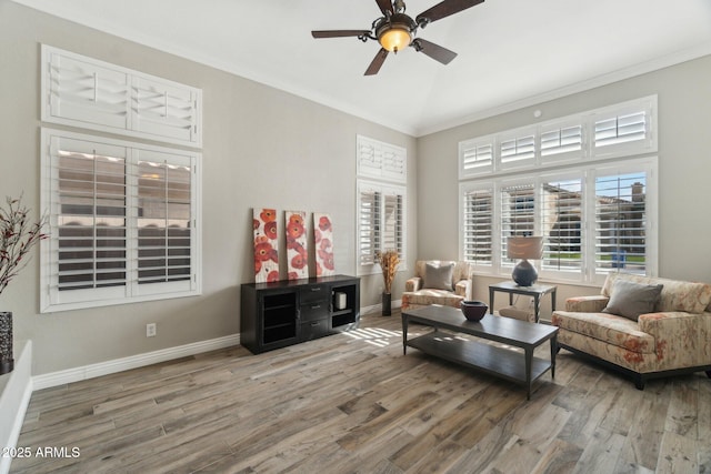 sitting room with hardwood / wood-style flooring, ceiling fan, and ornamental molding