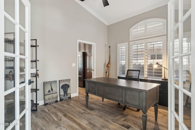 home office with hardwood / wood-style flooring, ceiling fan, ornamental molding, and high vaulted ceiling