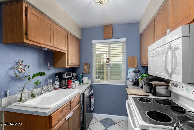 kitchen featuring light countertops, white appliances, and brown cabinetry