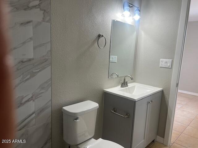 7136 W Cheryl Dr, Peoria, AZ 85345 - bathroom featuring toilet, tile patterned flooring, vanity, and a textured wall