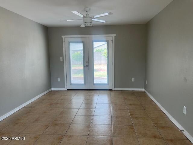7136 W Cheryl Dr, Peoria, AZ 85345 - tiled empty room featuring baseboards, french doors, and ceiling fan
