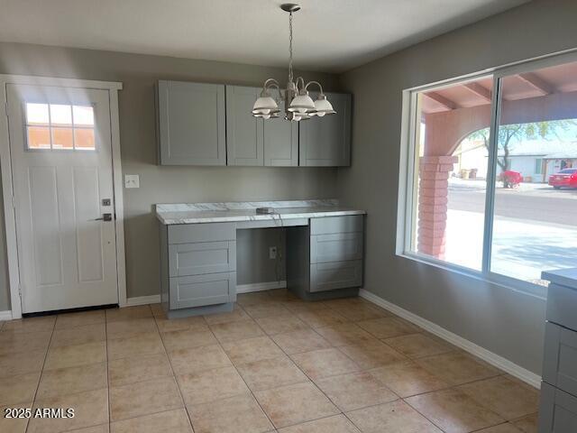 7136 W Cheryl Dr, Peoria, AZ 85345 - kitchen featuring an inviting chandelier, a wealth of natural light, gray cabinets, and light countertops