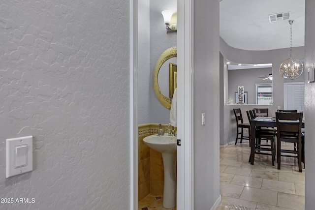 6694 S Banning St, Gilbert, AZ 85298 - interior space featuring tile patterned floors, a sink, visible vents, an inviting chandelier, and a textured wall
