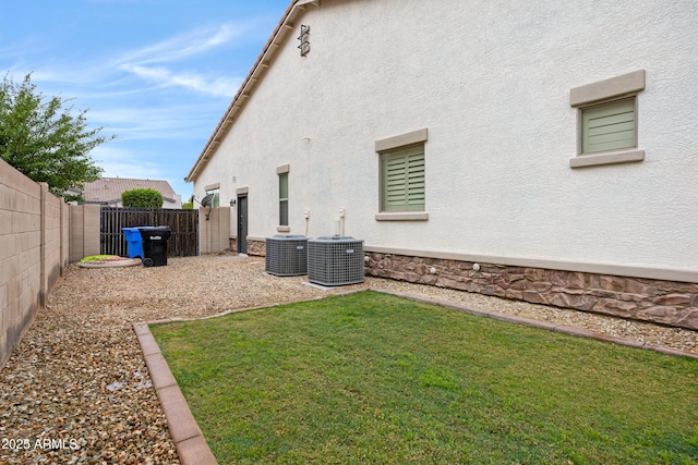 6694 S Banning St, Gilbert, AZ 85298 - exterior space featuring a fenced backyard, central air condition unit, and stucco siding