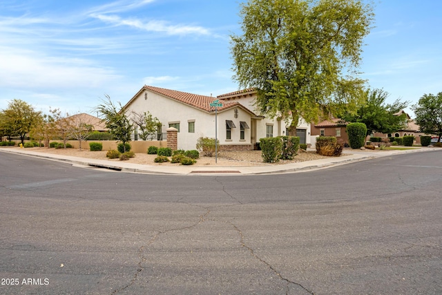 6694 S Banning St, Gilbert, AZ 85298 - mediterranean / spanish home featuring a tile roof, stucco siding, and fence