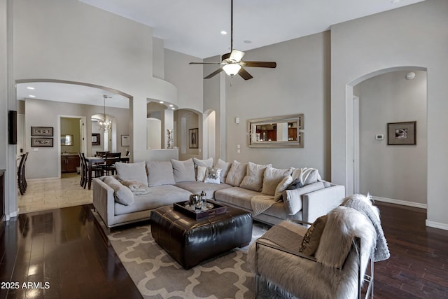 6694 S Banning St, Gilbert, AZ 85298 - living area with a towering ceiling, wood finished floors, arched walkways, baseboards, and ceiling fan with notable chandelier