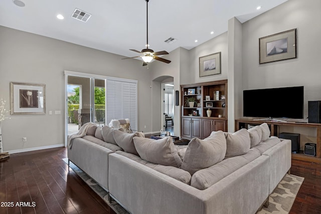 6694 S Banning St, Gilbert, AZ 85298 - living room featuring arched walkways, visible vents, baseboards, and dark wood-style floors