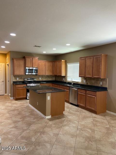 21136 N 36th Pl, Phoenix, AZ 85050 - kitchen with appliances with stainless steel finishes, a center island, tasteful backsplash, recessed lighting, and dark countertops