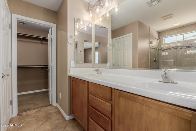 21136 N 36th Pl, Phoenix, AZ 85050 - full bathroom featuring a shower stall, double vanity, tile patterned floors, and a spacious closet