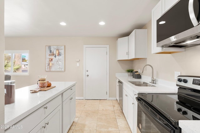 kitchen featuring sink, stainless steel appliances, white cabinets, and light tile patterned flooring