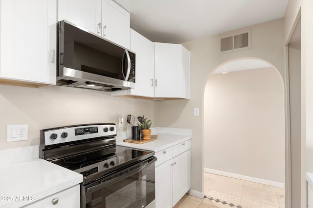 kitchen featuring white cabinetry, light tile patterned floors, and appliances with stainless steel finishes