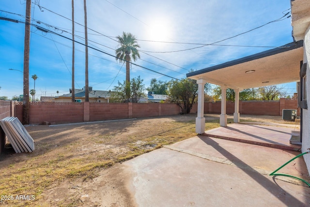 view of yard featuring central AC unit and a patio