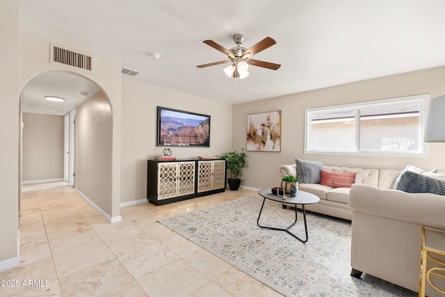 tiled living room with ceiling fan