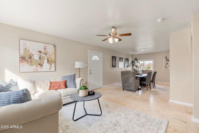 living room featuring light tile patterned floors and ceiling fan