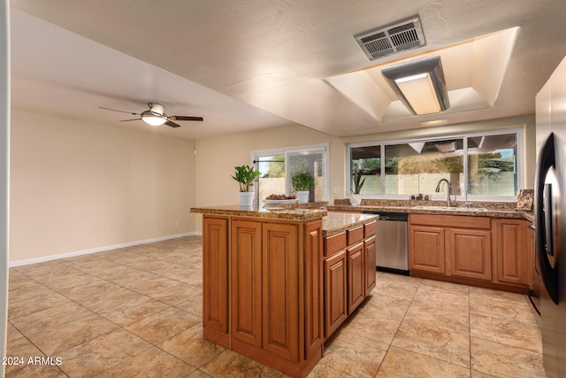 kitchen featuring ceiling fan, a center island, sink, stainless steel appliances, and light tile patterned floors