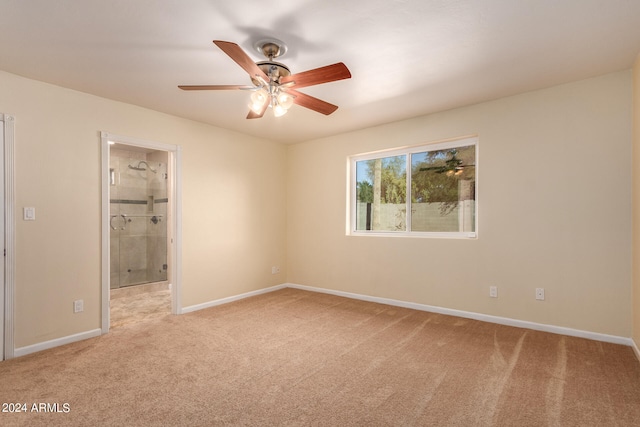 unfurnished bedroom with ceiling fan, light colored carpet, and ensuite bath