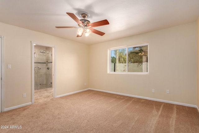 unfurnished bedroom featuring baseboards, connected bathroom, and light colored carpet