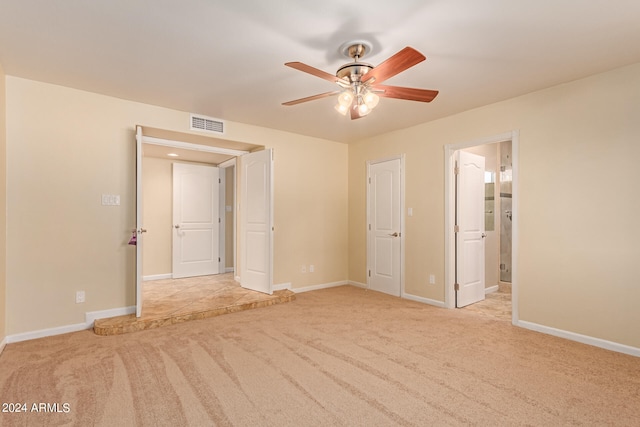 unfurnished bedroom featuring light colored carpet and ceiling fan