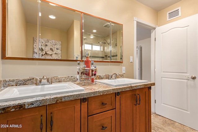 bathroom with a shower with shower door and vanity