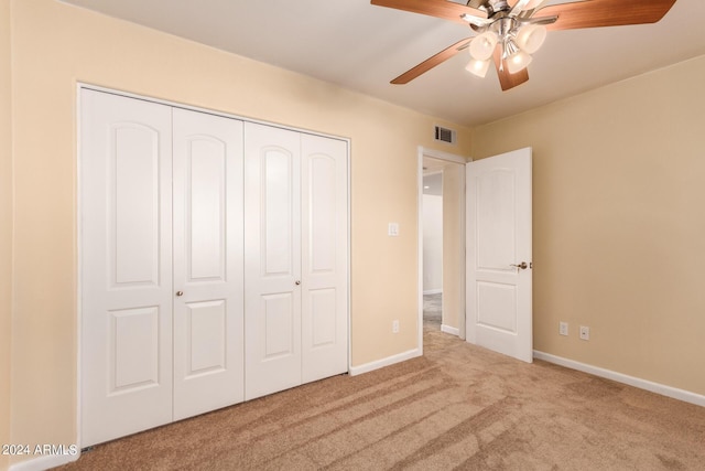 unfurnished bedroom with visible vents, a ceiling fan, carpet floors, a closet, and baseboards