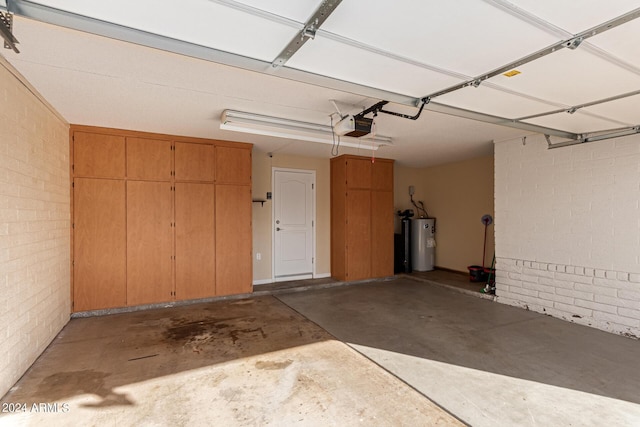 garage with water heater and a garage door opener