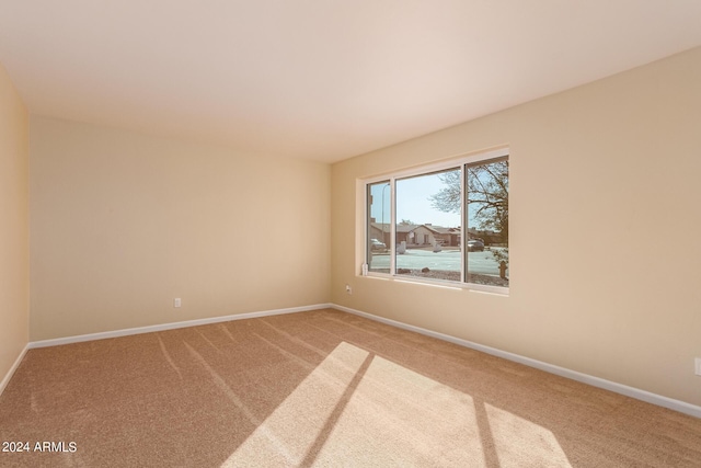 empty room featuring carpet floors and baseboards