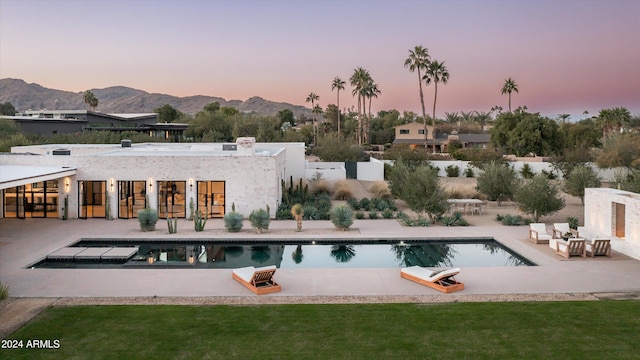 pool at dusk with a mountain view