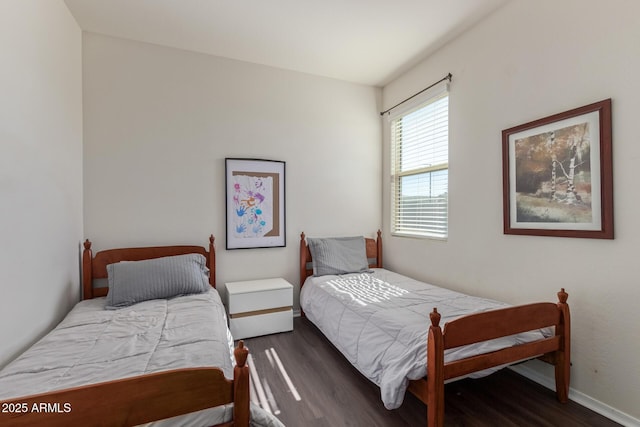 bedroom with baseboards and wood finished floors