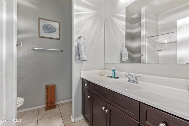 full bath featuring toilet, vanity, baseboards, and tile patterned floors