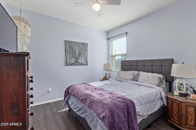 bedroom with dark wood-style floors, baseboards, and a ceiling fan