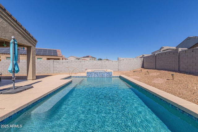 view of pool with a patio area, a fenced backyard, and a pool with connected hot tub